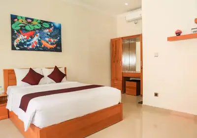 a bedroom with a large bed in a room at Wayan House Seminyak in Seminyak