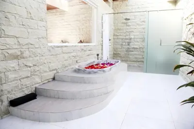 a bathroom with a fountain in the middle of a room at Villa Latour in Seminyak
