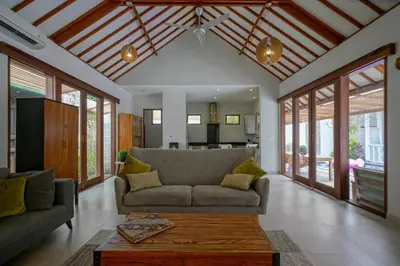 a living room with a couch and a table at Villa SU'KHA UMALAS in Canggu