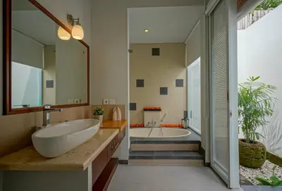 a bathroom with a large sink and a tub at Villa SU'KHA UMALAS in Canggu