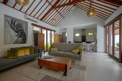 a living room with a couch and a coffee table at Villa SU'KHA UMALAS in Canggu