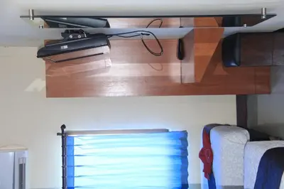 a wooden shelf in a room with two beds at Asher Bali Transit in Kuta