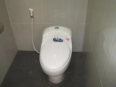 a bathroom with a white toilet in a stall at Asher Bali Transit in Kuta