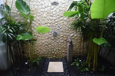 a bathroom with a shower with plants in it at Villa Verde in Seminyak
