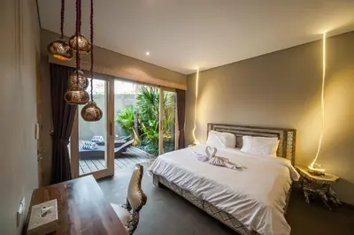 a bedroom with a bed with a flower on it at Luxury Villas Merci Resort 3BR Seminyak #2 in Kuta