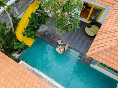 an overhead view of a man playing in an inflatable at La Mira Villa Seminyak by Ini Vie Hospitality in Seminyak