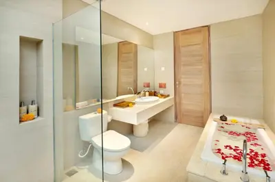 a bathroom with a toilet and a sink and a tub at La Mira Villa Seminyak by Ini Vie Hospitality in Seminyak