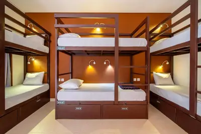a bunk bed room with three bunk beds in it at Gelatik Bed And Breakfast in Seminyak