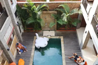 an overhead view of a swimming pool with a swan at Gelatik Bed And Breakfast in Seminyak