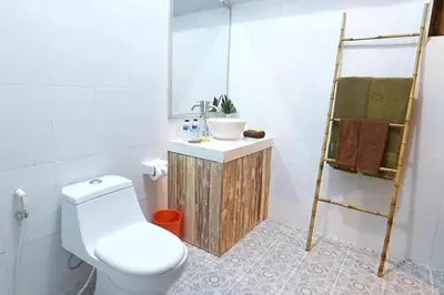 a bathroom with a toilet and a sink at Kubu Kak Dudung Villas in Jimbaran