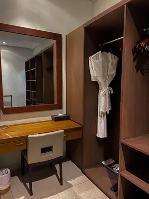 a bathroom with a desk and a mirror and a chair at Nyaman Villas Seminyak in Seminyak