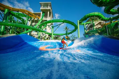 a person riding a wave on a water slide at Pondok Anyar Hotel in Kuta