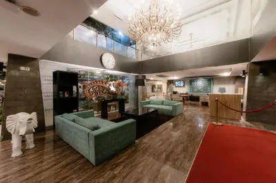 a large lobby with couches and a clock on the wall at Amaroossa Suite Bali in Nusa Dua