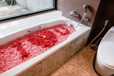 a bathroom with a tub filled with red crystals at Amaroossa Suite Bali in Nusa Dua