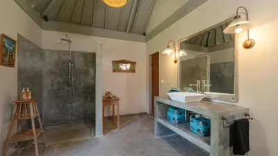 a bathroom with a sink and a shower at Villa Koyama by Villa Finder in Seminyak