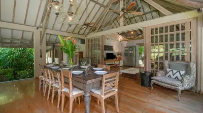 a dining room with a table and chairs at Villa Koyama by Villa Finder in Seminyak