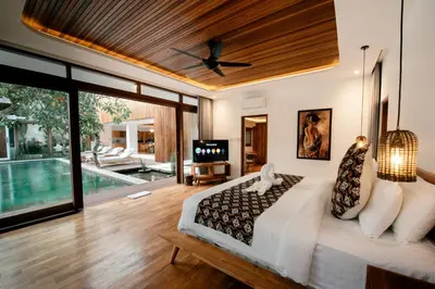 a bedroom with a bed with a ceiling fan at Luxury Villa Seminyak near beach and Potato Head in Seminyak