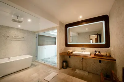 a bathroom with a tub and a sink and a mirror at Luxury Villa Seminyak near beach and Potato Head in Seminyak
