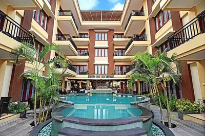 a swimming pool in the middle of a building at Kuta Town House Apartments in Kuta
