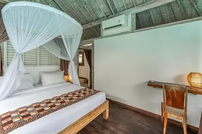 a bedroom with a bed with a mosquito net at Villa Laksmana Hideaway 2 - Surrounded by water- 2bd villa with fantastic pool! in Seminyak