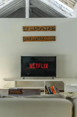 a television on a white shelf in a living room at Villa Laksmana Hideaway 2 - Surrounded by water- 2bd villa with fantastic pool! in Seminyak
