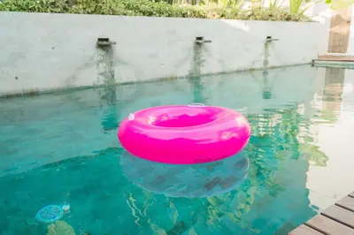 a pink frisbee in the water in a pool at VILLA DUNA Seminyak Bali in Seminyak