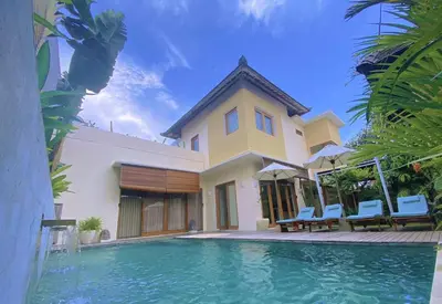 a house with a swimming pool in front of it at VILLA DUNA Seminyak Bali in Seminyak
