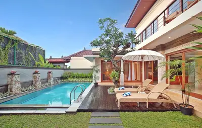 a swimming pool in the backyard of a house at Kubu GWK Resort in Jimbaran