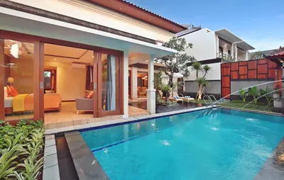 a swimming pool in the backyard of a house at Kubu GWK Resort in Jimbaran