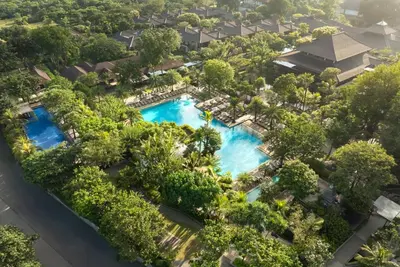an aerial view of a resort pool with trees at Padma Resort Legian in Legian