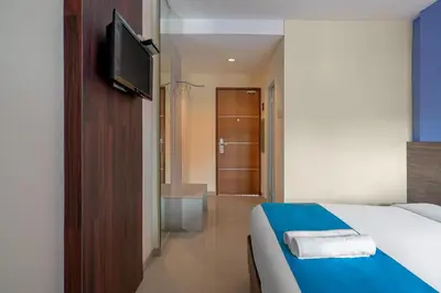 a hotel room with a bed and a television at Dream @ Jimbaran in Jimbaran