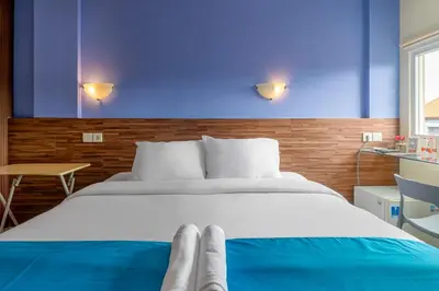 a bedroom with a large bed with a blue wall at Dream @ Jimbaran in Jimbaran