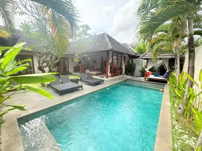 a swimming pool in front of a villa at Nil Villa Seminyak in Seminyak