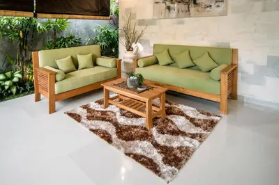 a living room with two couches and a coffee table at Sandi Agung Villa Bidadari in Seminyak