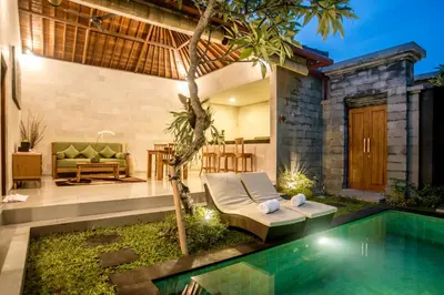 a villa with a swimming pool and a house at Sandi Agung Villa Bidadari in Seminyak