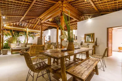 a dining room with a wooden table and chairs at Villa Namu by Alfred in Bali in Seminyak