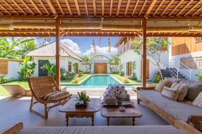 a living room with a couch and a pool at Villa Namu by Alfred in Bali in Seminyak