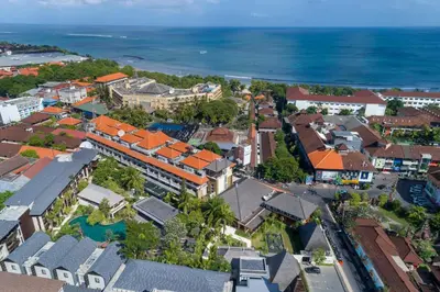 an aerial view of a town with houses and the ocean at Ramayana Suites and Resort in Kuta