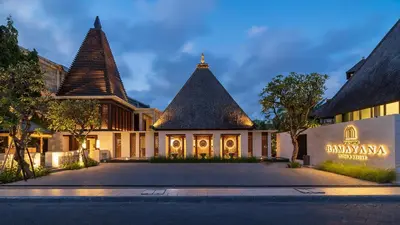an exterior view of a building with two towers at Ramayana Suites and Resort in Kuta