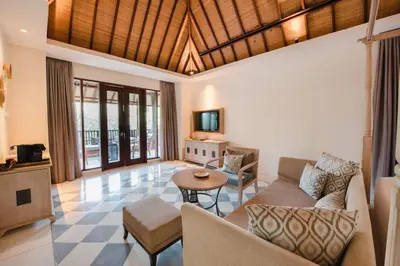 a living room with a couch and a table at Ramayana Suites and Resort in Kuta