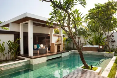 a swimming pool in front of a villa at The Samaya Seminyak Bali in Seminyak