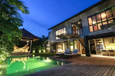 an exterior view of a house with a swimming pool at Villa Suku Berawa in Canggu