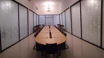 a long conference room with a long table and chairs at Rumah Retret Bethania in Kuta