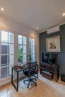 a office with a desk and a chair in a room at Mosan House - unique art-filled gem in perfect location a short walk from the beach or Seminyak Square including AC office for remote working in Seminyak