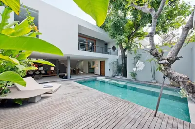 an external view of a house with a swimming pool at VILLA OLYMPIA in Seminyak
