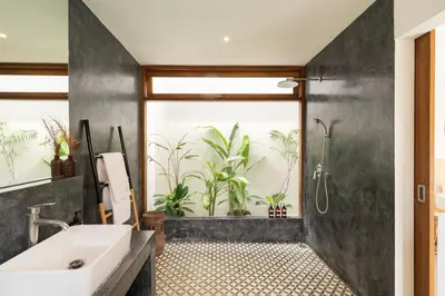 a bathroom with a sink and a shower with plants at House of Bagera by Alfred in Bali in Seminyak