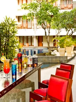 a bar with drinks on a table in a building at The Rani Hotel & Spa in Kuta
