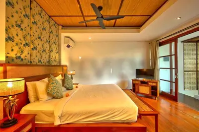 a bedroom with a bed and a ceiling fan at Beautiful Bali Villas - 6 mins walk to the beach in Legian