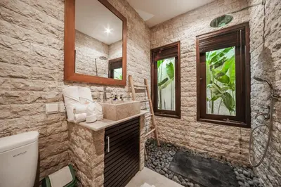 a bathroom with a sink and a toilet at Villa Pearl Seminyak in Seminyak