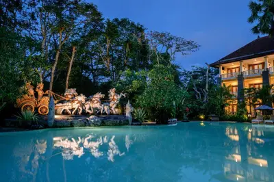 a swimming pool in front of a building at Hotel Kumala Pantai in Legian